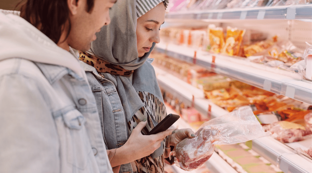 couple buying supermarket smartphone